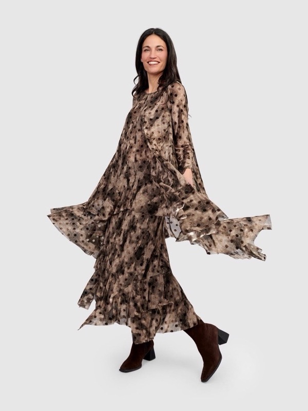 A brown printed tiered dress caught mid-turn